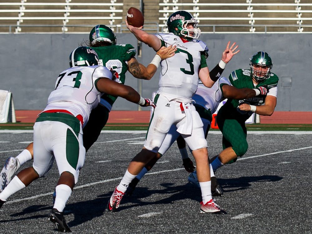 Eastern Michigan defensive lineman Pat O'Connor hits the arm of Mississippi Valley State quarterback Austin Bray, ruining a pass, during the Eagles' 61-14 win over the Delta Devils in Ypsilanti, 2 Sept.