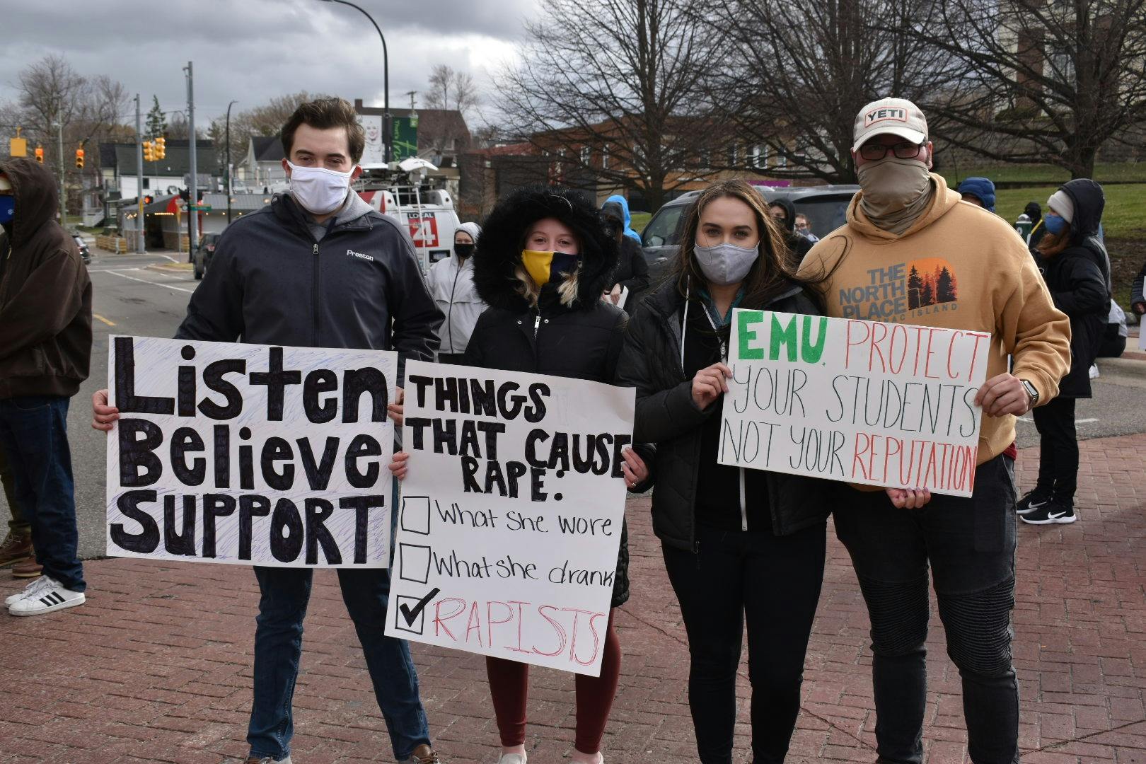 EMU students holding signs at the March 28 protest against sexual assault