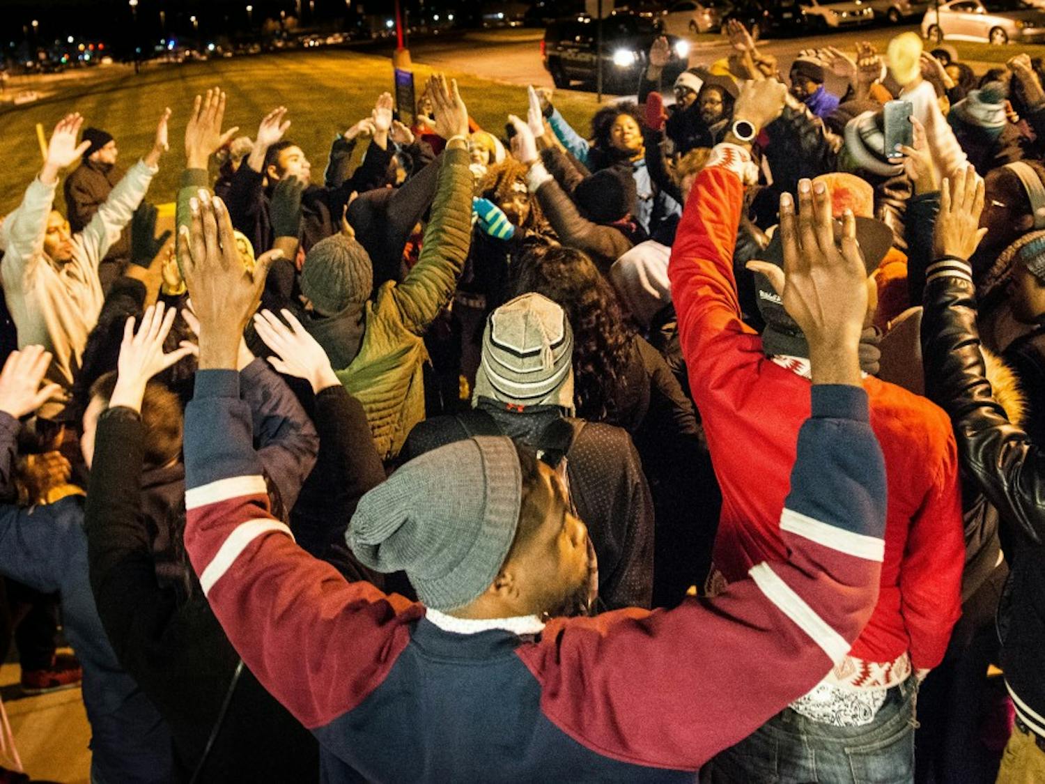 Students chant “hands up, don't shoot,” during a peaceful protest of the Ferguson verdict on EMU's campus tonight. Photo by Sage Stephens.