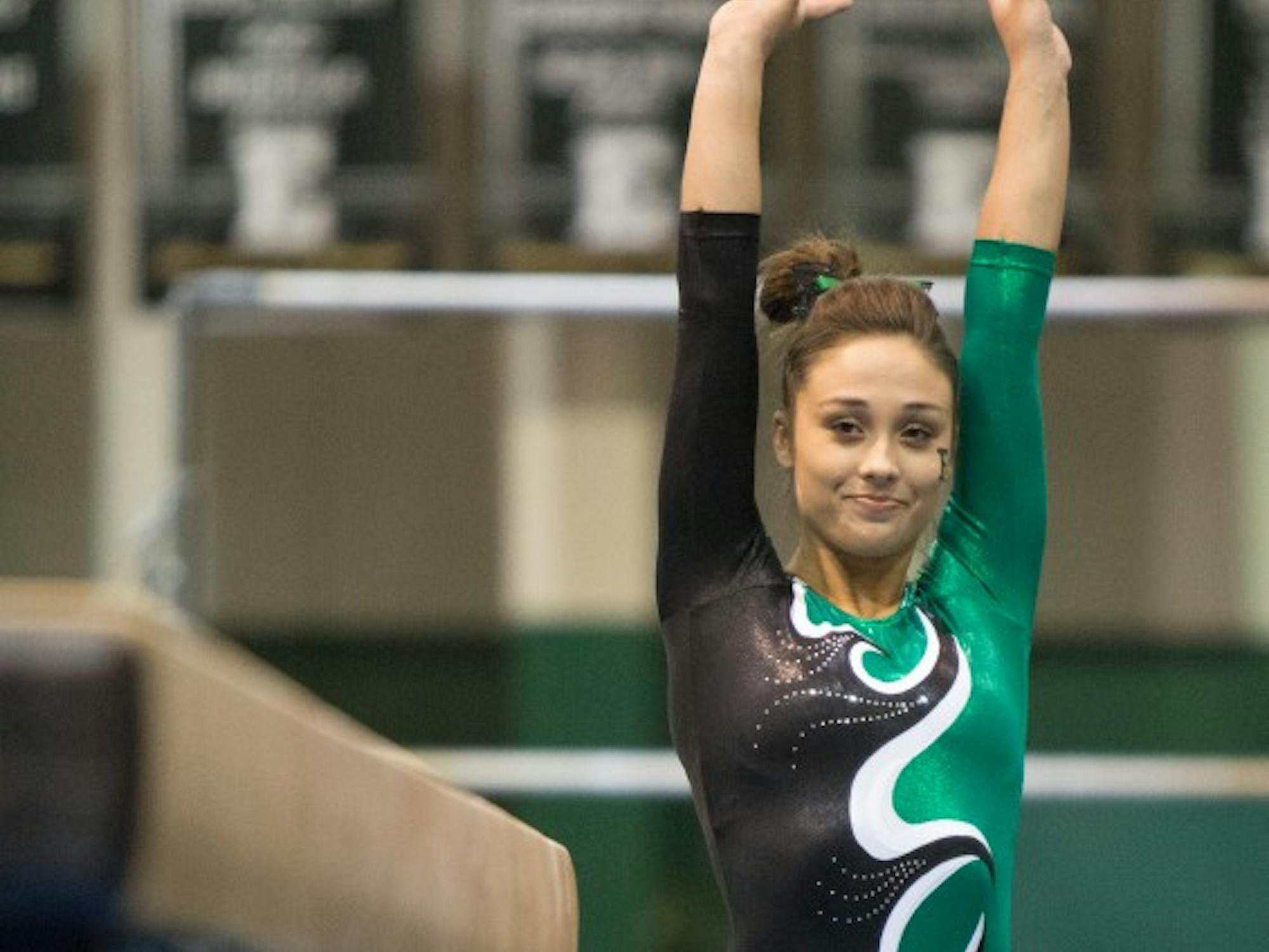 Eastern Michigan freshman Kelsie Brooks gets ready to perform on the beam in the Eagles 195.925-194.600 loss to Central Michigan Friday night.