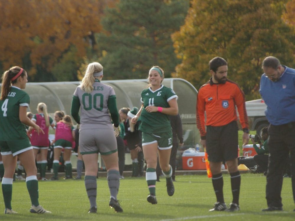 EMU midfielder Kristin Hullibarger runs to teammates in pregame introductions at Scicluna Field on Oct. 24.