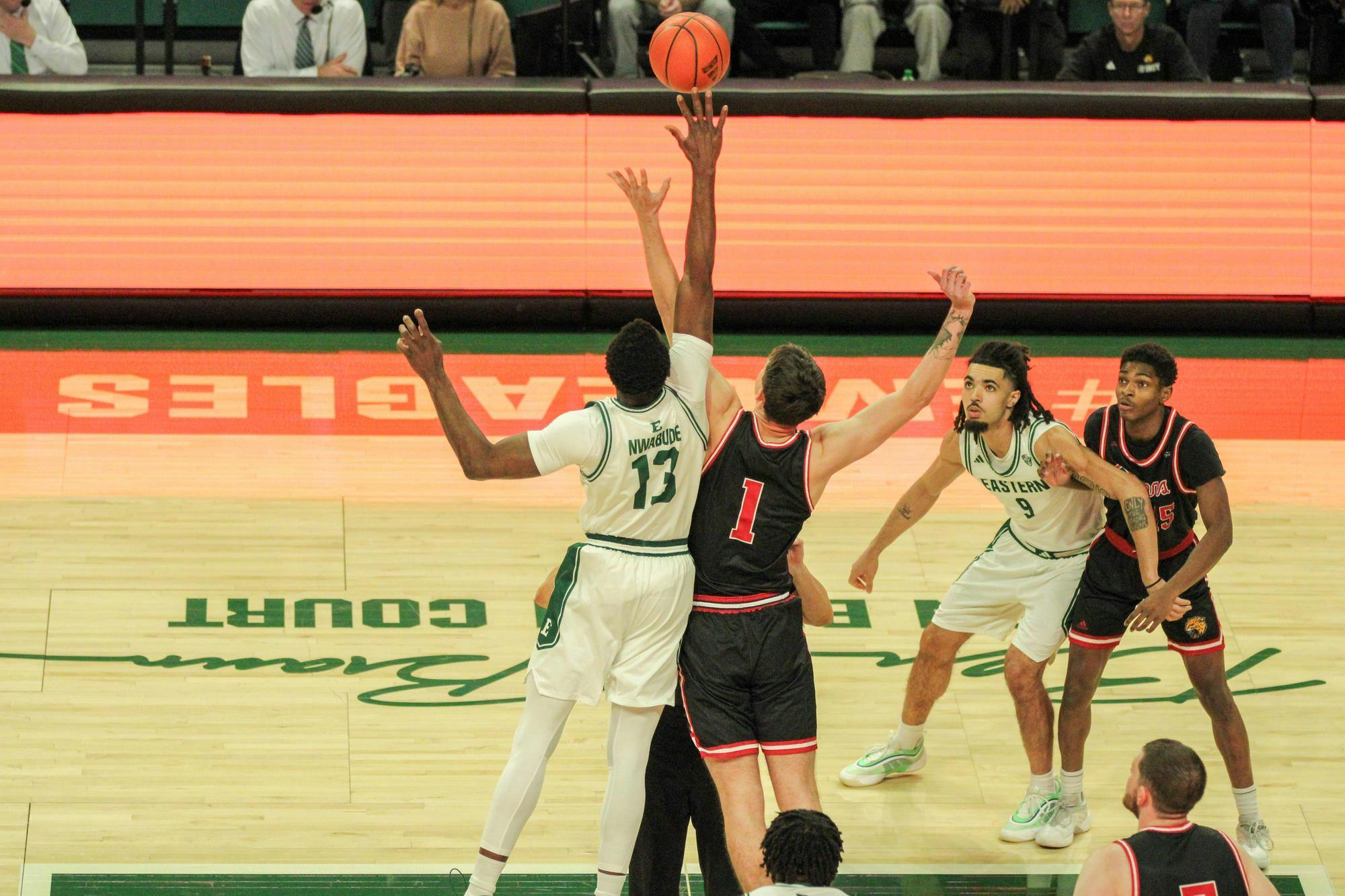 #13, in a white jersey, getting the ball before IU Indy, in a black jersey