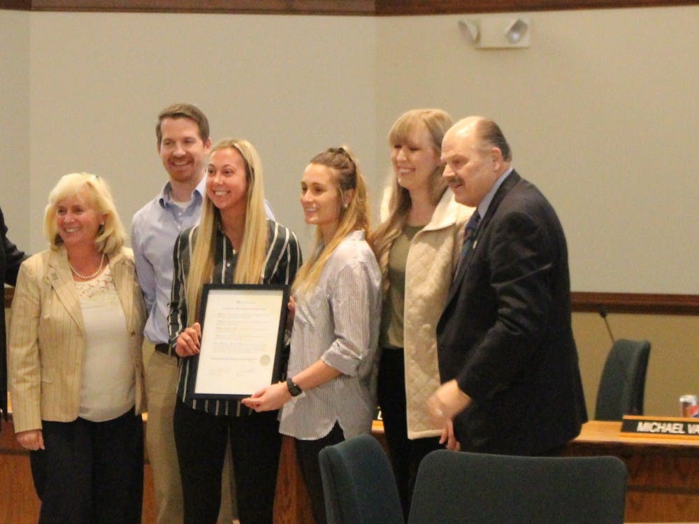 The Board of Regents recognized the achievement of EMU’s women’s volleyball with the team’s first Mid-American Conference win and first trip to the NCAA Tournament. Pictured from left to right: Peter Winters, assistant coach; Jordan Smith, Alyssa Laface; Darcy Dorton, assistant coach; President Smith.