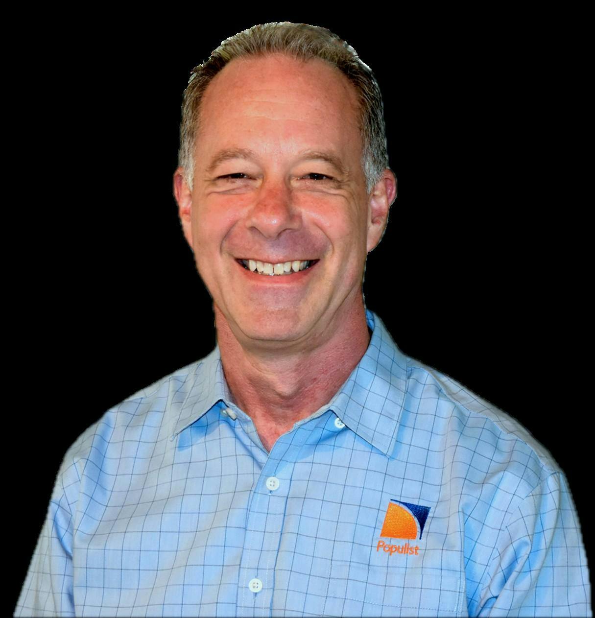 A headshot of a man smiling.