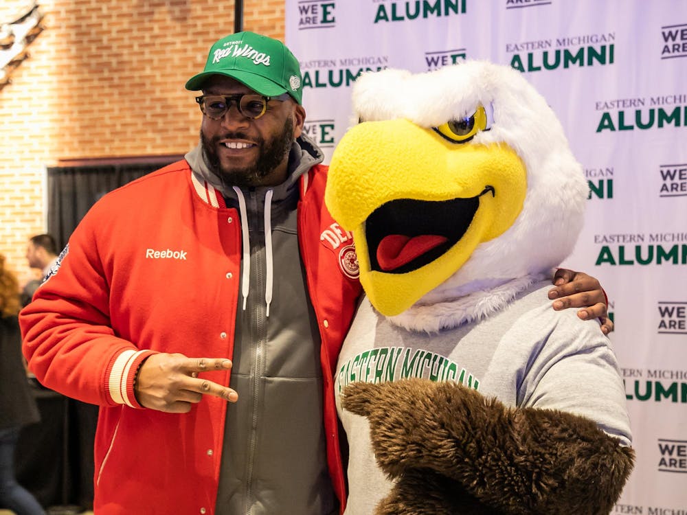 Fans pose with Swoop during the 2023 EMU and Illitch Sports collaboration event, TRUEMU night at the Detroit Red Wings game.