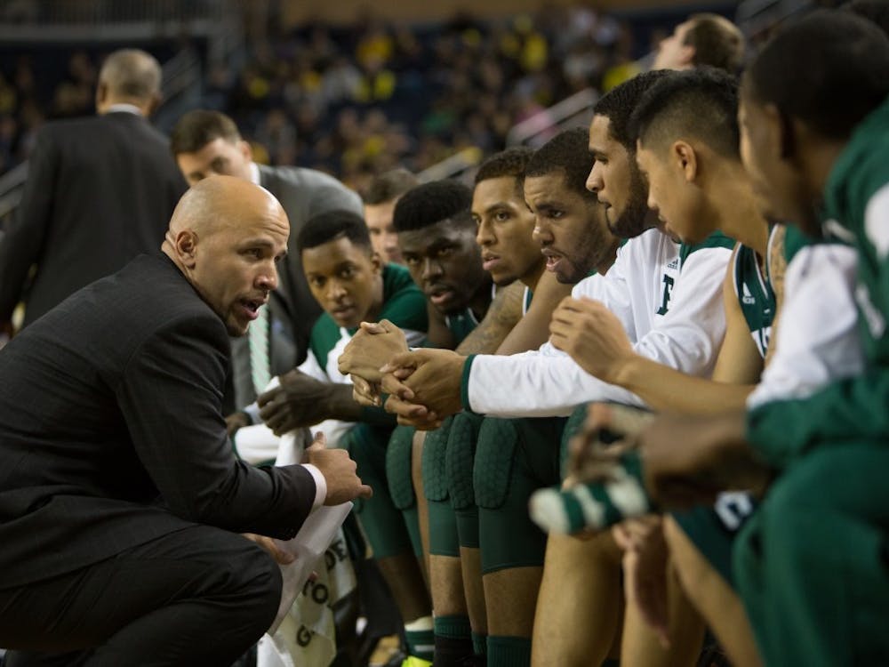 Eastern Michigan assistant coach Mike Brown tells the team to keep it's composure for final minute of play in the Eagles 45-42 win over the University of Michigan Dec. 9 2014 at Crisler Center in Ann Arbor.