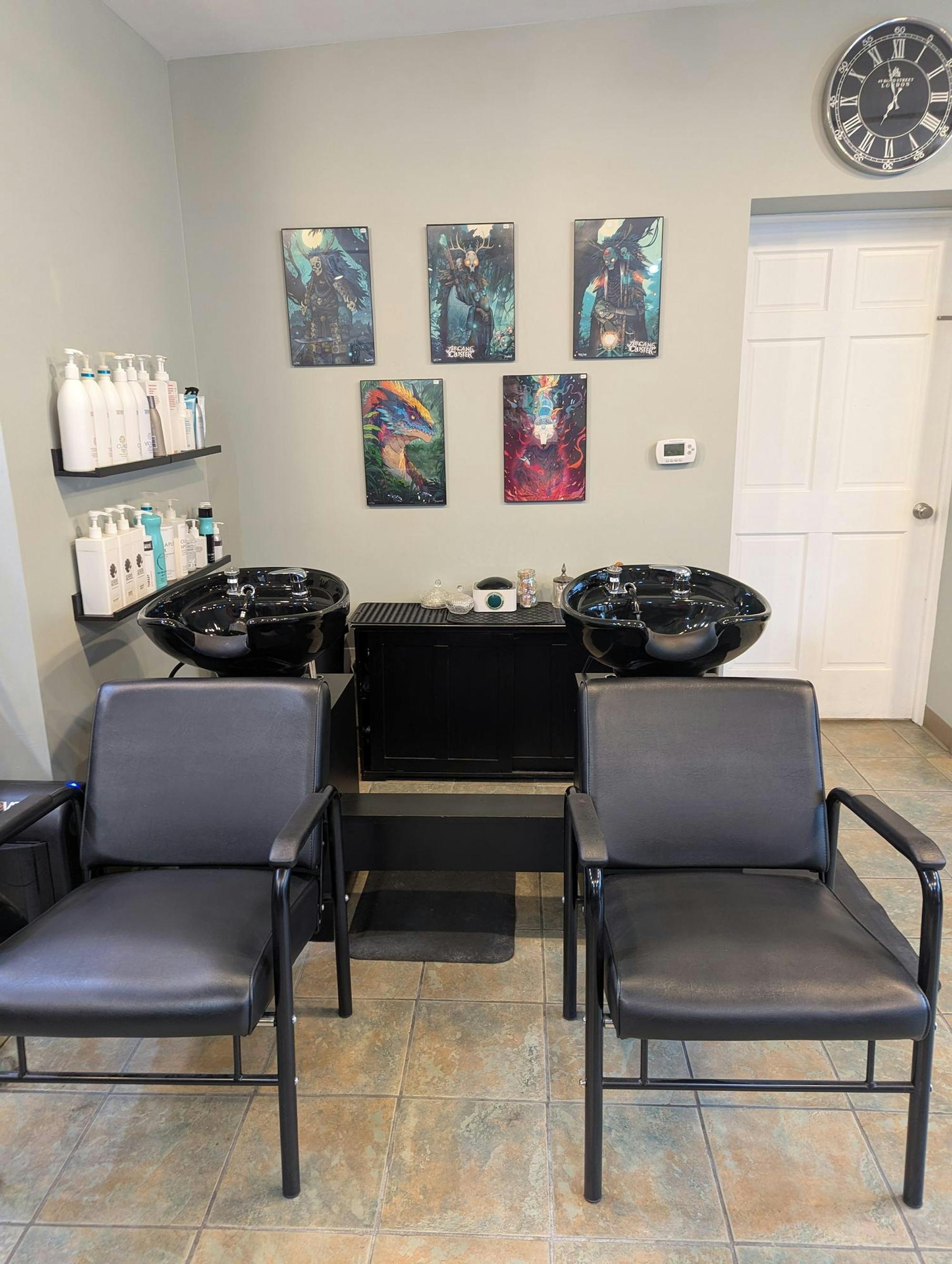 Two hair washing chairs with digital illustrations of dragons displayed in the background.