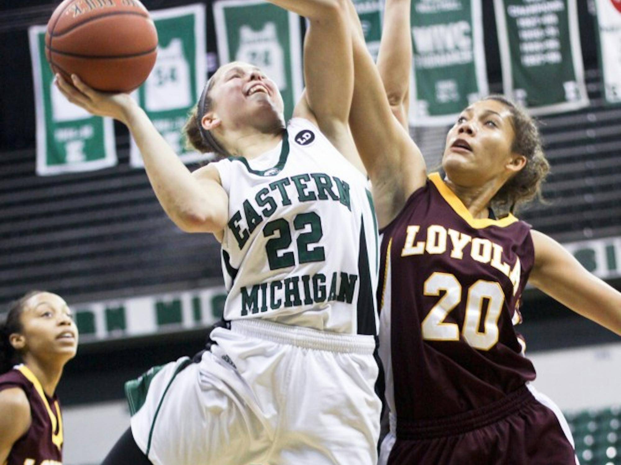 Senior guard Cassie Schrock (22) goes for a layup against Loyola’s Troy Hambric (20). Schrock was a leading scorer for the Eagles with 16 points. 