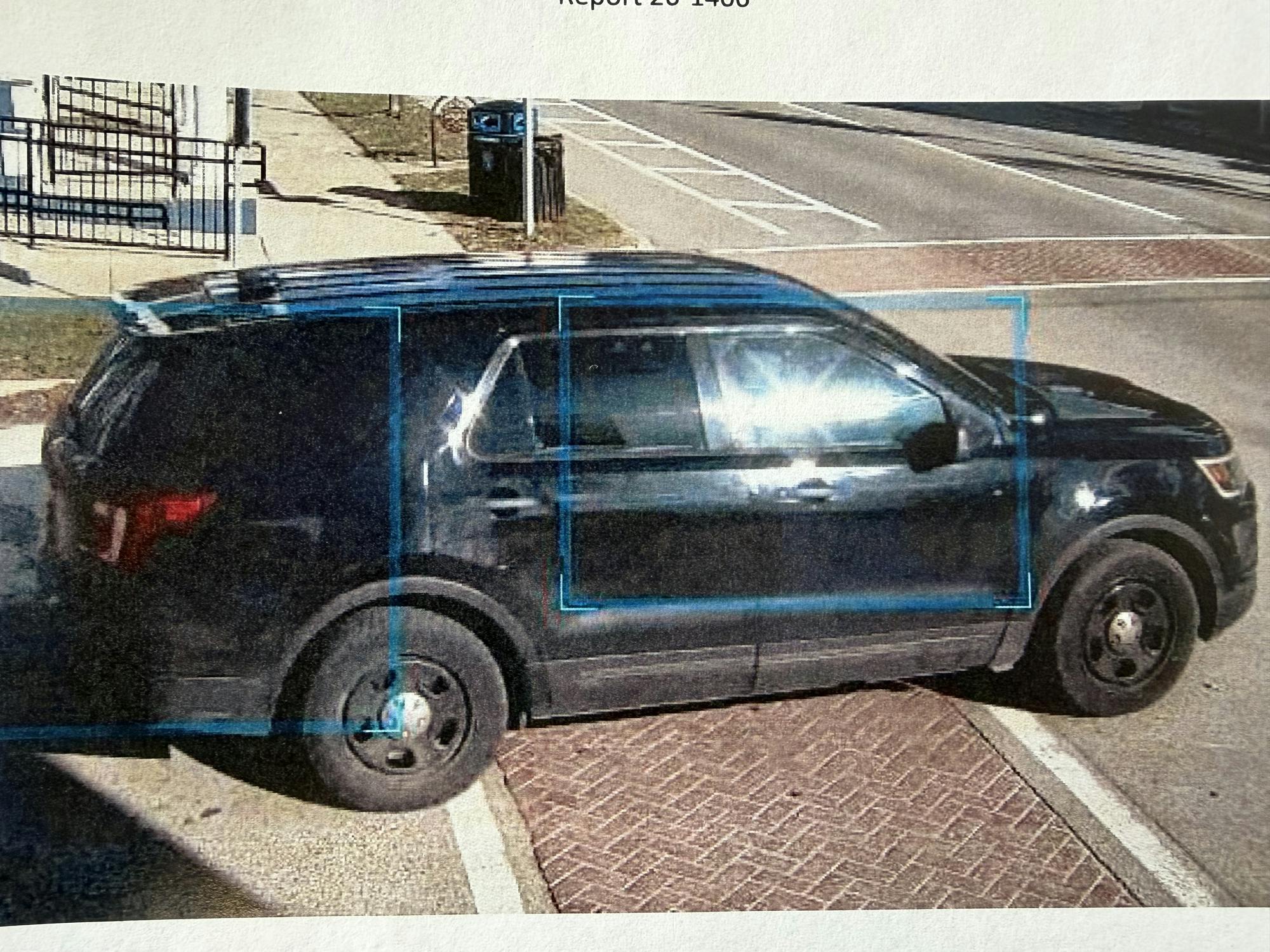 A dark SUV that is suspected to be a Ford Explorer pulling into the intersection of W. Cross Street and Ballard Street