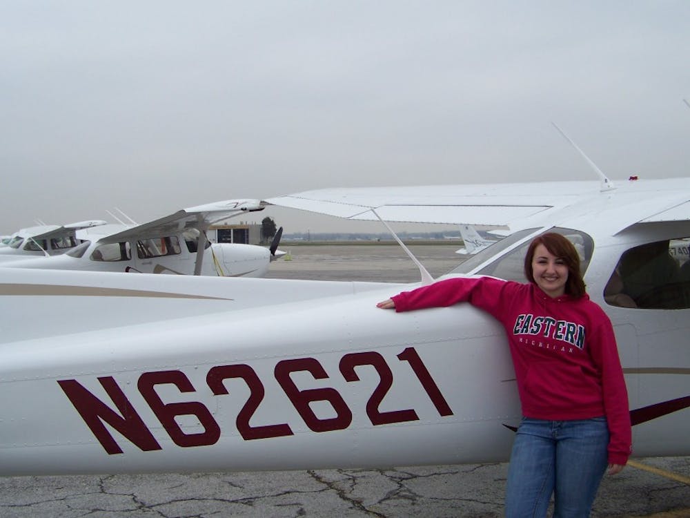 	Kym Mosher stands in front of the Cessna 172 Skyhawk, in which she recorded her first solo flight in early April.
