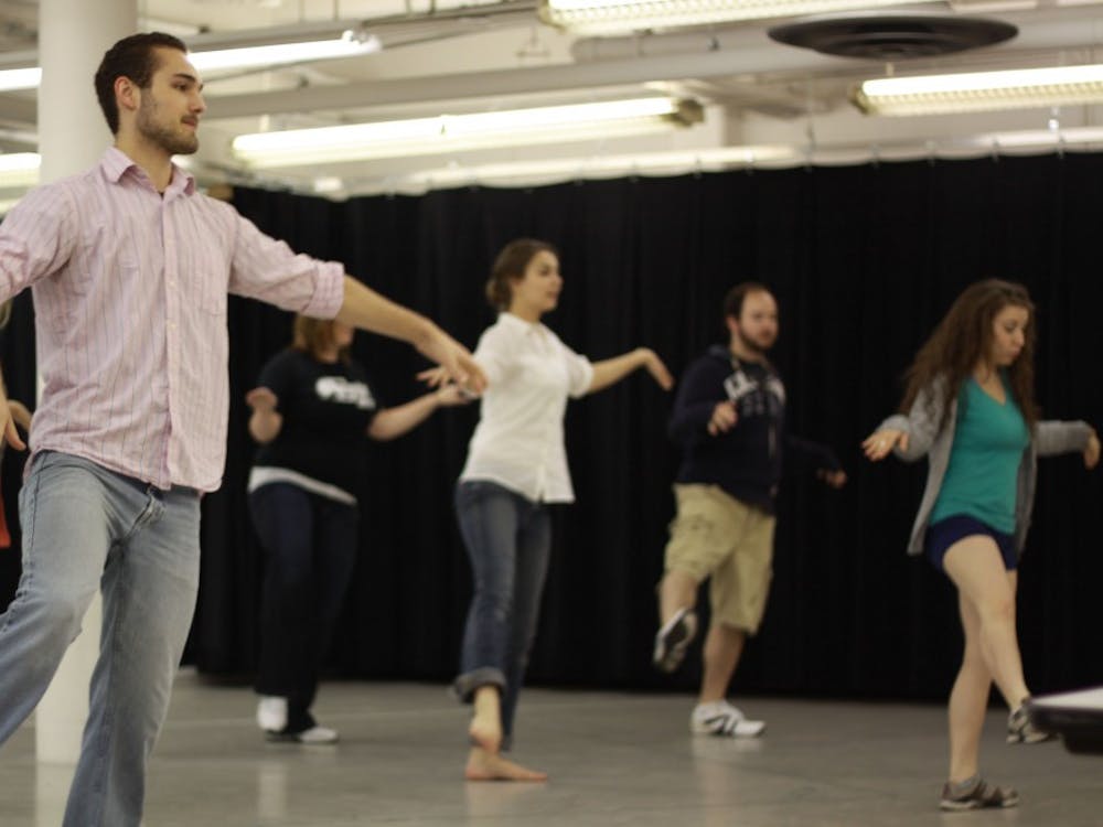 (Left) The cast of “Little Me” surrounds Andy Orscheln during rehearsals beneath Dining Commons 1. (Above)  Tyler Knauf practicing the choreography of the Neil Simon musical reimagined by professor Ken Stevens.