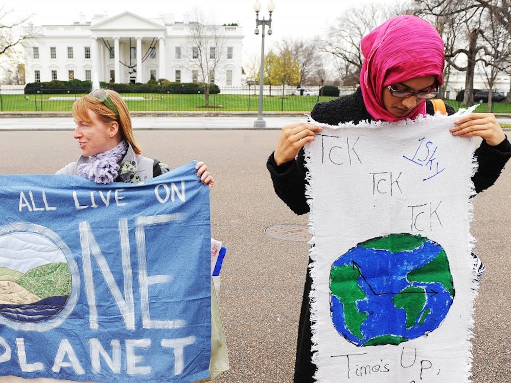 Environmental activists rally in front of the White House Dec. 4 to call on the Obama administration to step up its efforts on climate changge in Copenhagen and domestically, for a better financial situation.