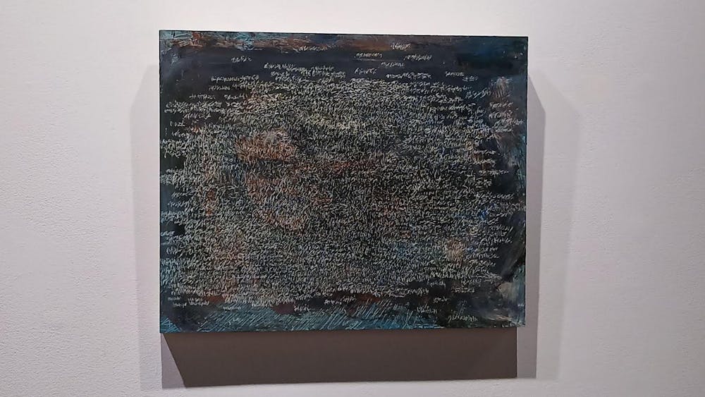 An abstract painting of scratches on a blue background hanging on a white wall.