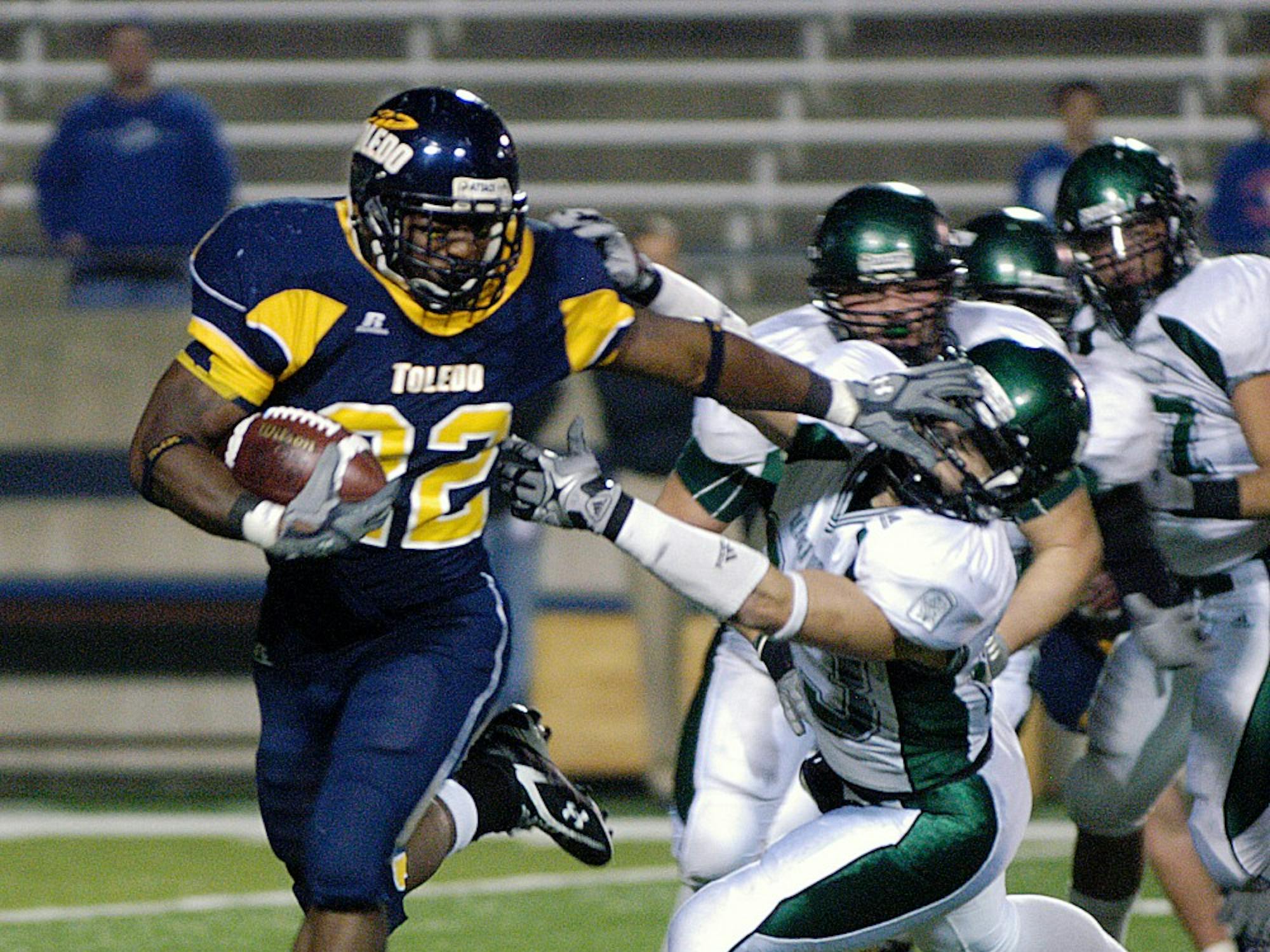 	Stiffarming tailback DaJuane Collins gains some of his 144 rushing yards in Toledo’s 47-21 win over EMU on Friday. Teammate Morgan Williams rushed for 155.
