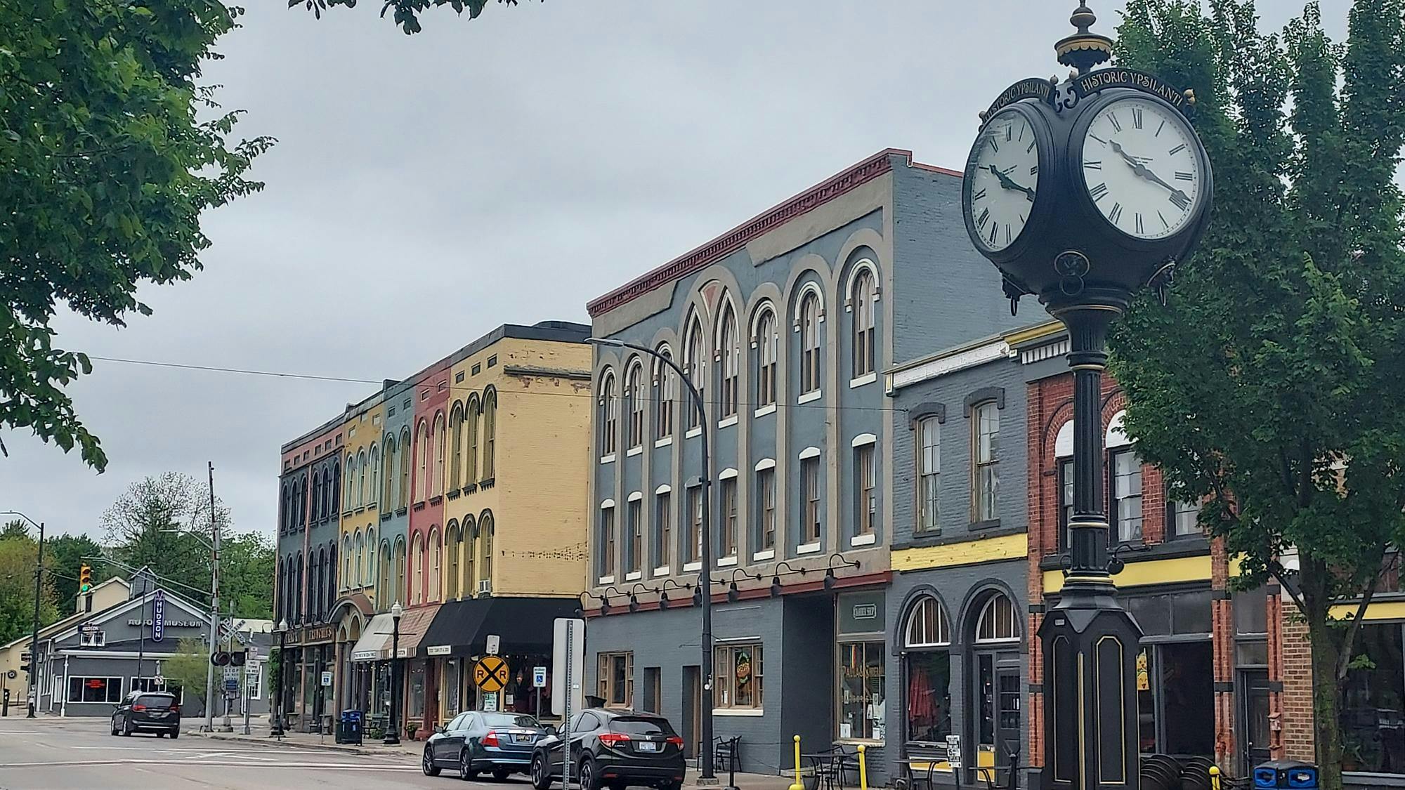 Colorful buildings house shops and restaurants along the Depot Town main street, with the city's clock post, at right, mounted in the middle of one of the pedestrian crosswalks.