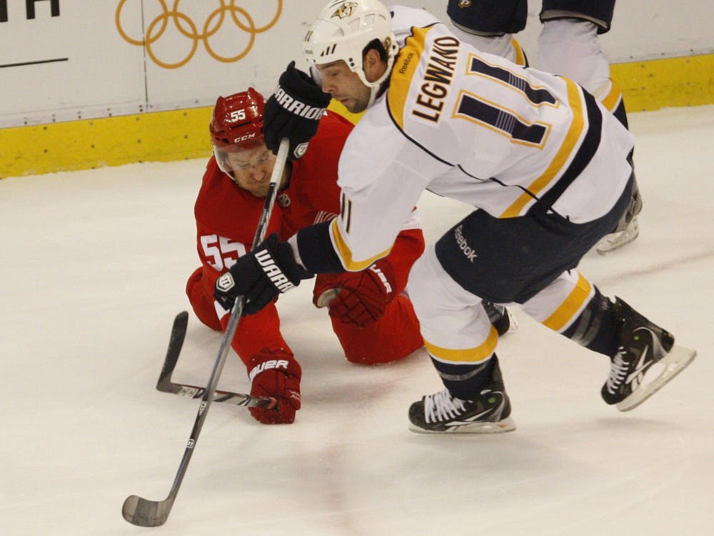 The Detroit Red Wings' Niklas Kronwall fights for the puck with the Nashville Predators' David Legwand (11) during first-period action in Game 4 of the Western Conference Quarterfinals on Tuesday, April 17, 2012, at Joe Louis Arena in Detroit, Michigan. (Kirthmon F. Dozier/Detroit Free Press/MCT)