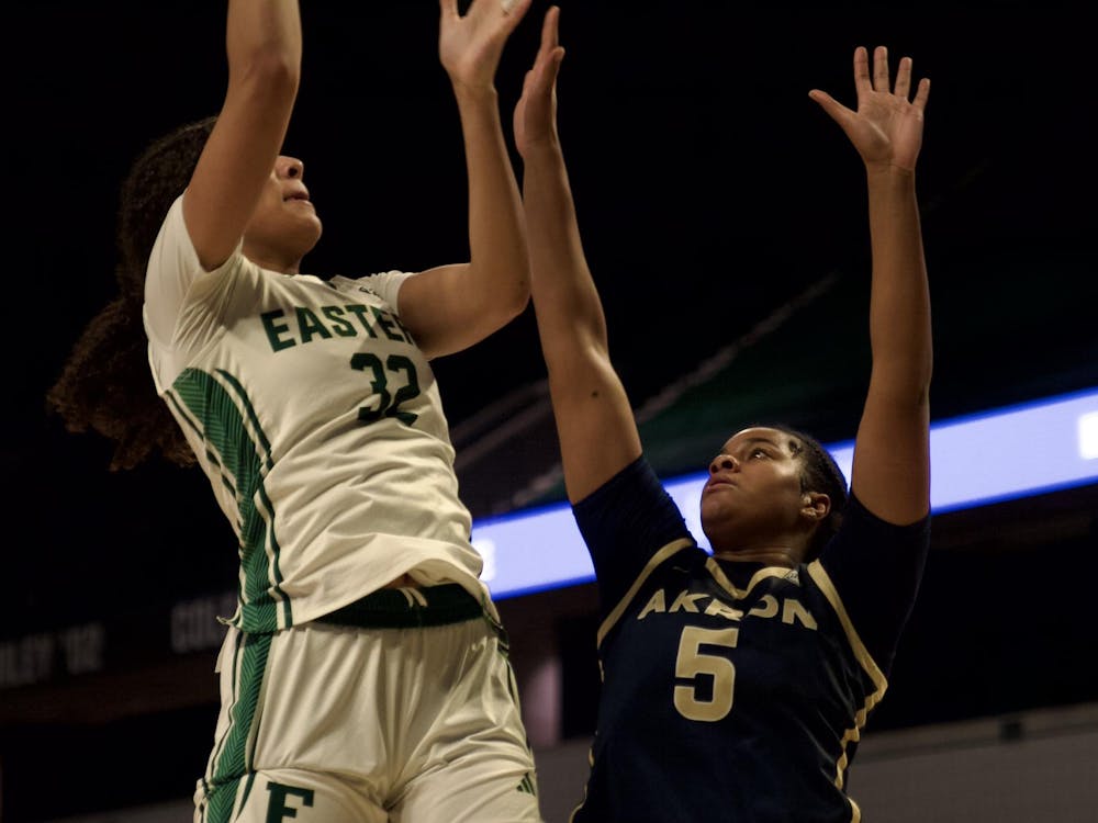 EMU's Tayra Eke (32) goes up with the ball against Akron's Lanae Riley (5). Photo taken February 7, 2024, at the George Gervin GameAbove Center.