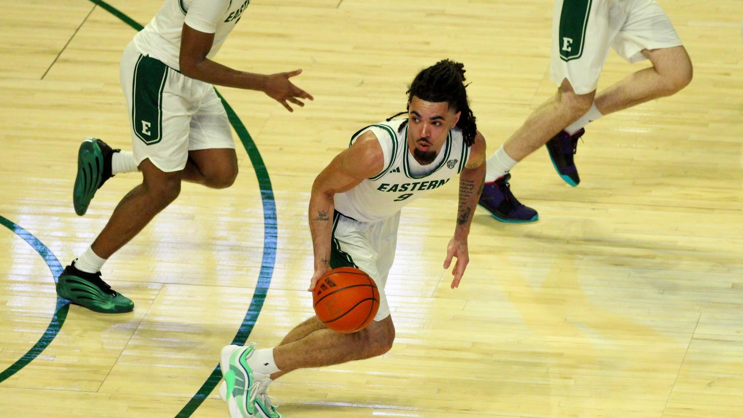 #9, in a white jersey, dribbling the ball
