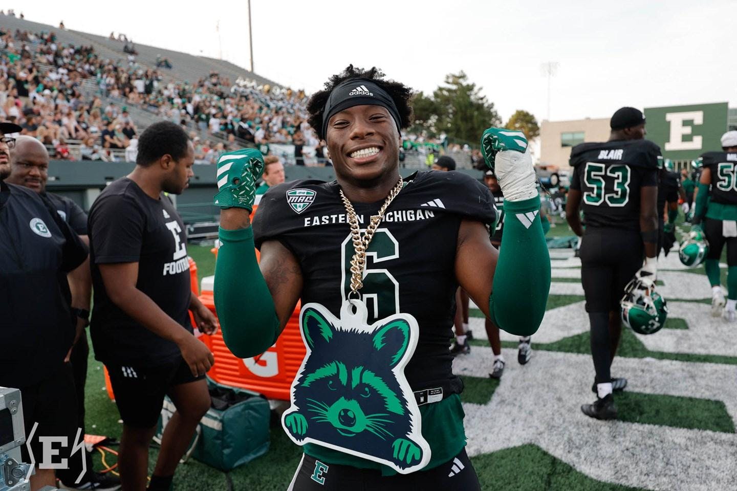 An Eastern Michigan football player wearing black and green flashes the "MACcoon" chain during the Eagles' Homecoming matchup against Louisiana Lafayette on Sept. 20, 2025.