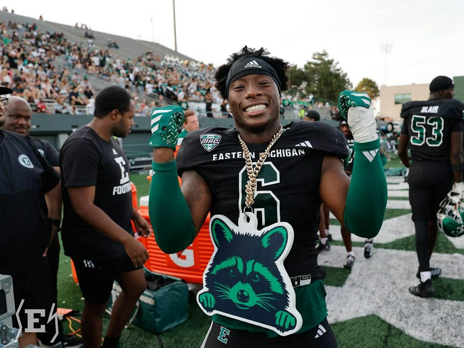 An Eastern Michigan football player wearing black and green flashes the "MACcoon" chain during the Eagles' Homecoming matchup against Louisiana Lafayette on Sept. 20, 2025.