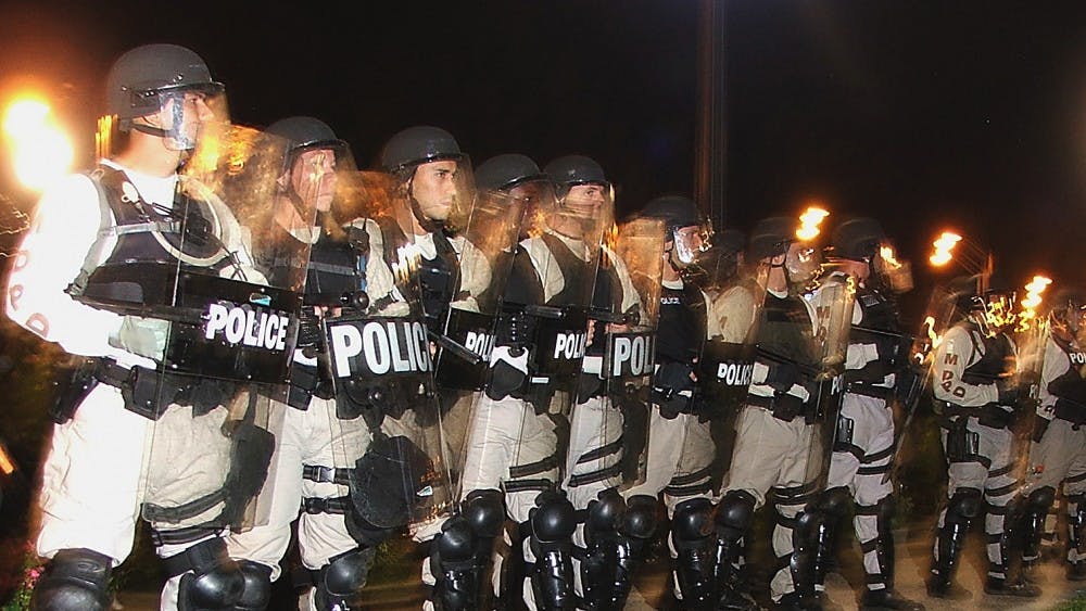Riot police surround the perimeter of Schenely Park during an anti-police brutality demonstration.