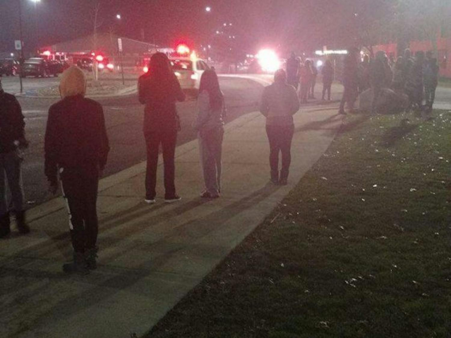 Students wait outside after being evacuated from Phelps Hall when a couch in the first floor lounge caught on fire.&nbsp;