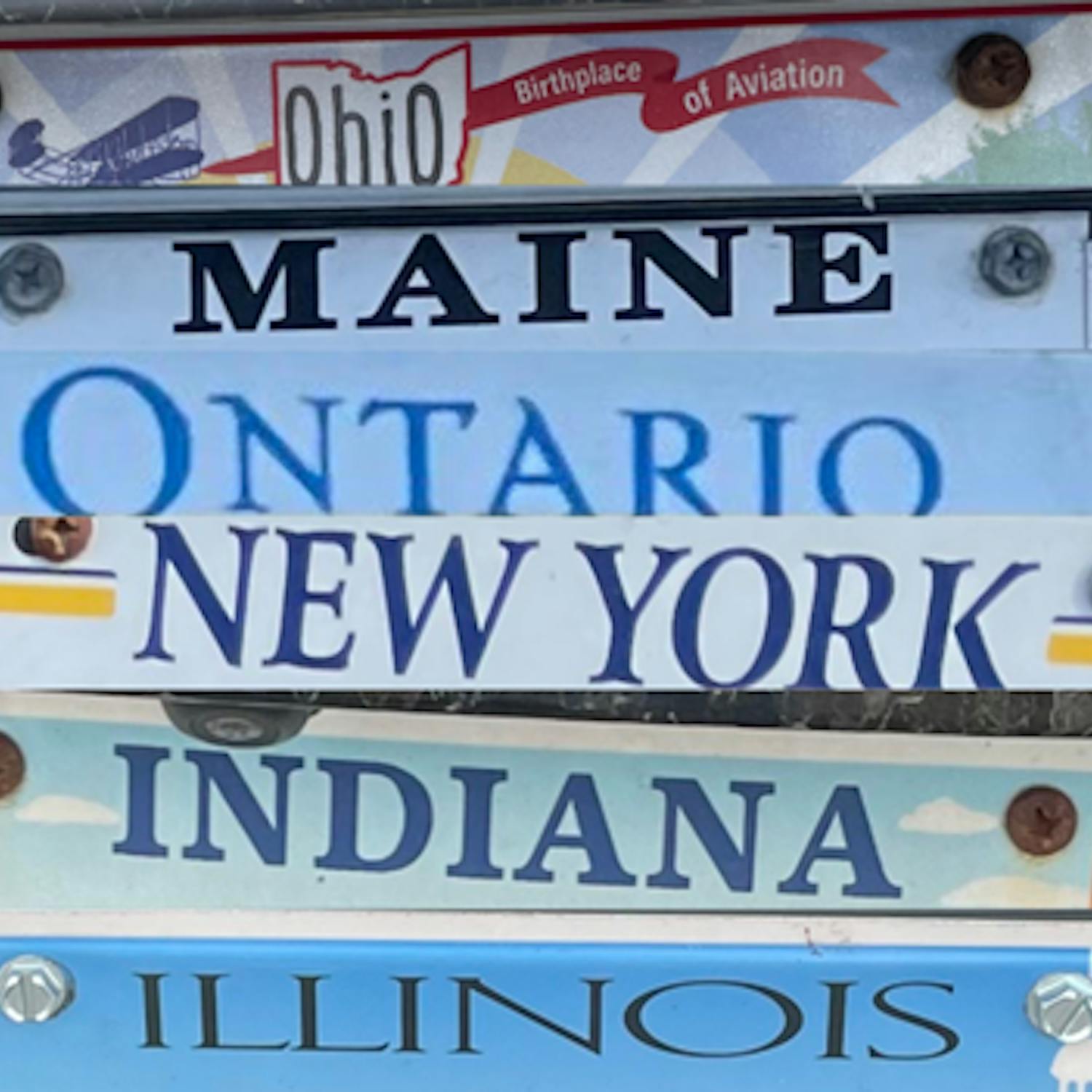 License plate car tags from Ohio, Maine, Ontario, New York, Indiana, and Illinois have been cropped and edited together into one image.