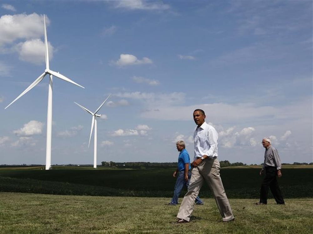 U.S. President Barack Obama walks with Jeff and Richard Heil (R) on the Heil Family Wind Farm while in Haverhill, Iowa, in this August 14, 2012, file photo. REUTERS/Larry Downing/Files