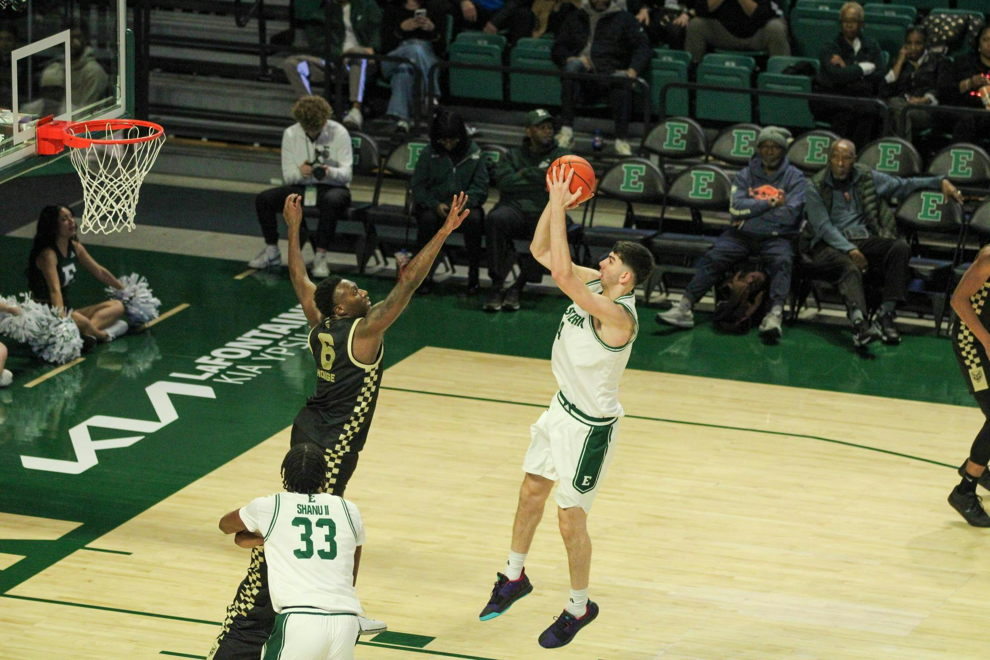#4, shooting the basketball, in a white jersey