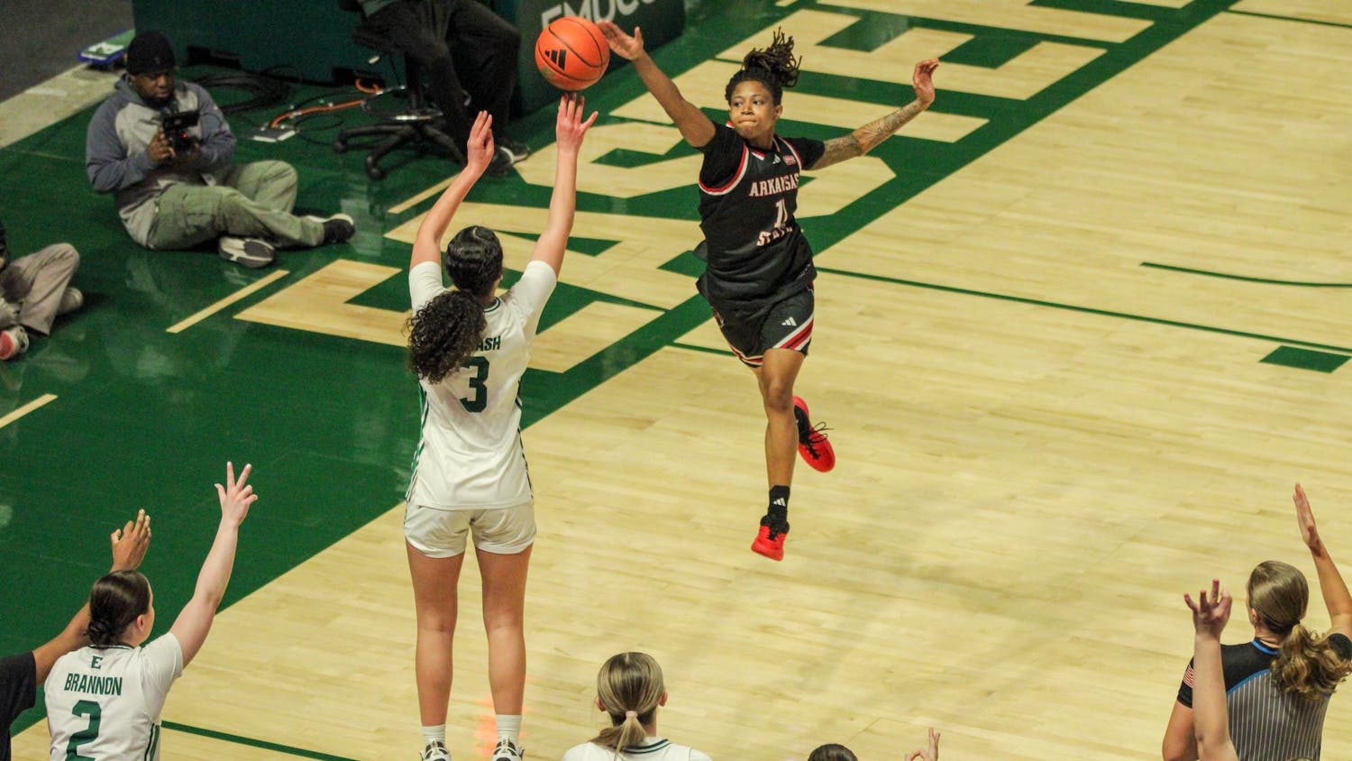 Eastern player, No. 3 in a white jersey, jumping to make a three-point shot.