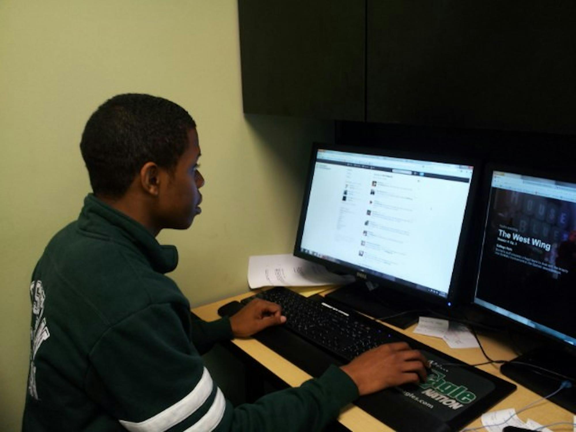 	EMU Student Government President Desmond Miller checks the Student Government Twitter feed.