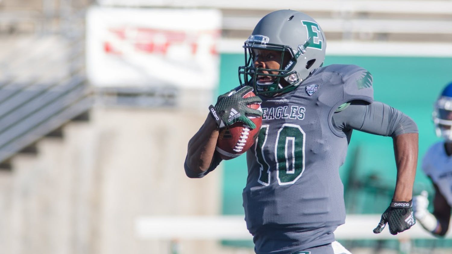 Eastern Michigan quarterback Reggie Bell runs towards the end zone in EMU's 37-27 victory over Buffalo Saturday in Ypsilanti.