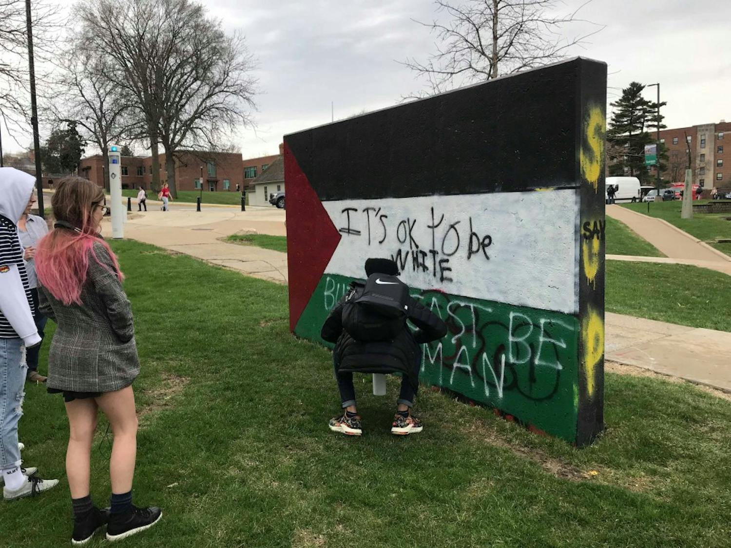 Students Paint Responses to the Controversial Phrase Written on the Freedom Walls