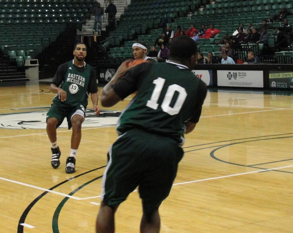 EMU men's basketball green and white