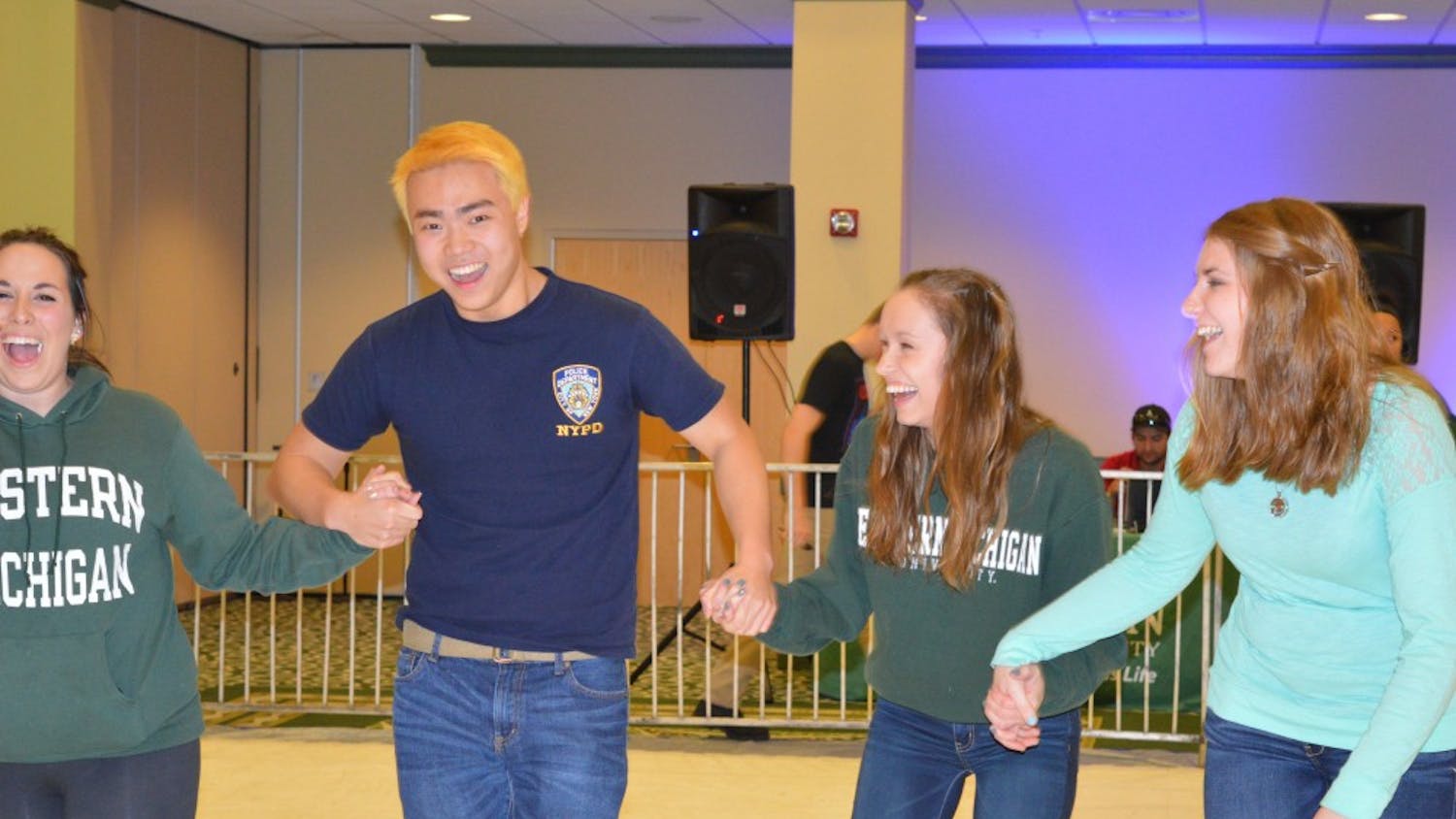 Students hold on to each&nbsp;other for balance while ice skating in the Student Center Ballroom.