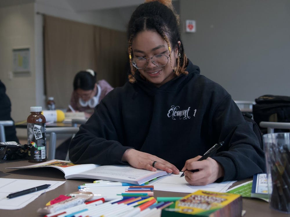 Student Hermes Wilson spends the evening expressing his creativity for CORE's Crafternoon. Photo taken March 22, 2024, at EMU's Lakehouse in Ypsilanti, MI.