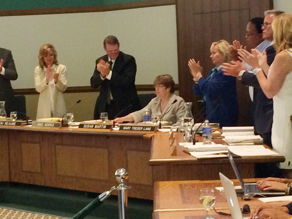 The Eastern Michigan University Board of Regents gives university president Susan Martin a standing ovation following her final president's report during the Board of Regents meeting in Welch Hall, 16 June.
