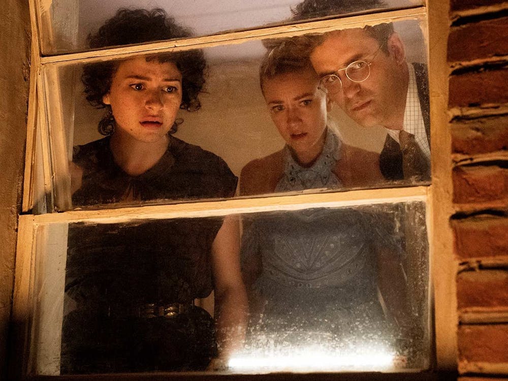 The characters of Search Party peer out of a window. Retrieved from IMDb.
