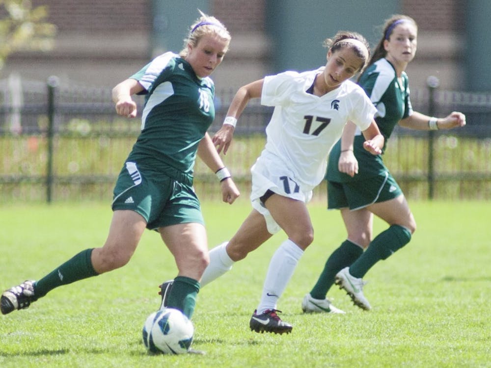 Eastern Michigan's forard Bianca Rossi, left, kicks the ball with Michigan State's freshman midfielder Sarah Kovan running next to her on Sunday, Sept. 9, 2012 at DeMartin Stadium in East Lansing, Mich. The Spartans defeated the Eastern Michigan Eagles 2-0. James Ristau/The State News