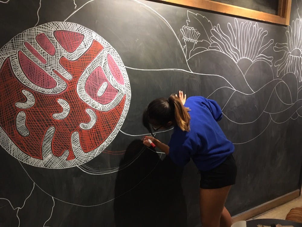 Sidney Phan draws on Sweetwater’s chalk walls. She displays her artwork on her Instagram: @phan.sidney