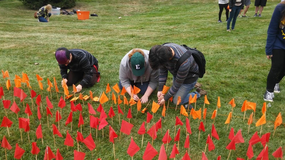 Students lined individual flags to make one big flag on the lawn outside Pray-Harrold.