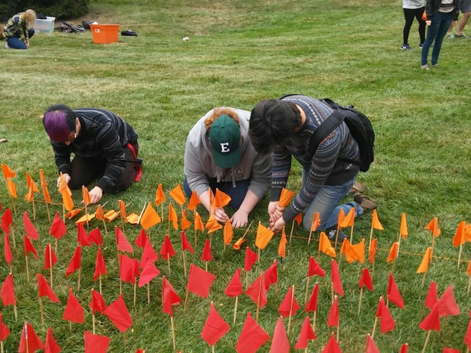 Students lined individual flags to make one big flag on the lawn outside Pray-Harrold.
