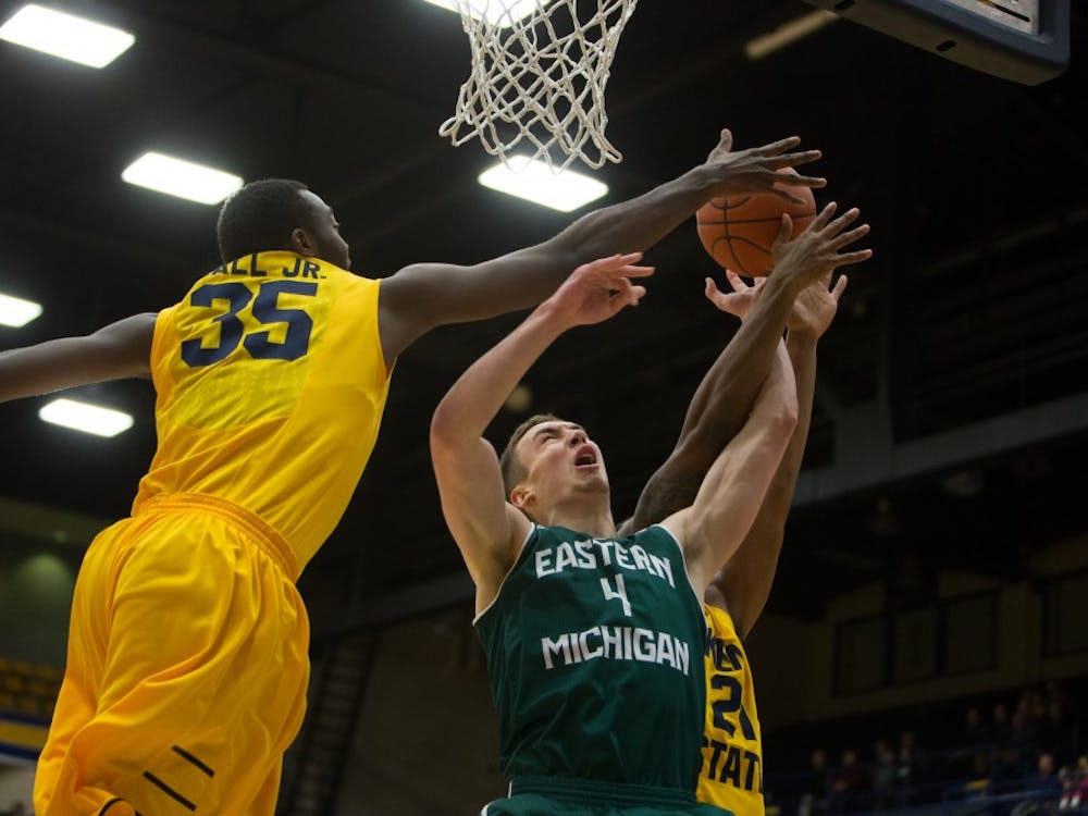 Eastern Michigan forward Brandon Nazione is blocked in the Eagles 65-59 loss to Kent State Wednesday night in Kent, OH.