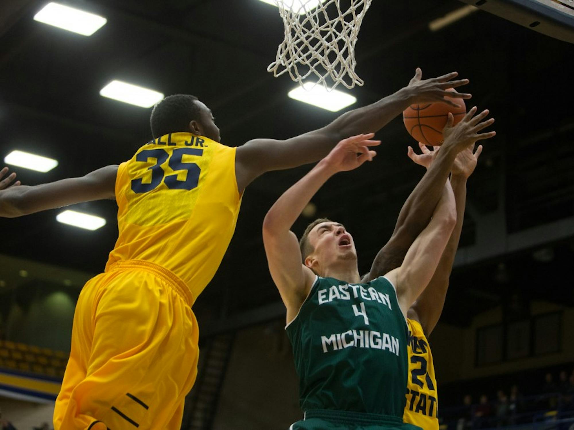 Eastern Michigan forward Brandon Nazione is blocked in the Eagles 65-59 loss to Kent State Wednesday night in Kent, OH.