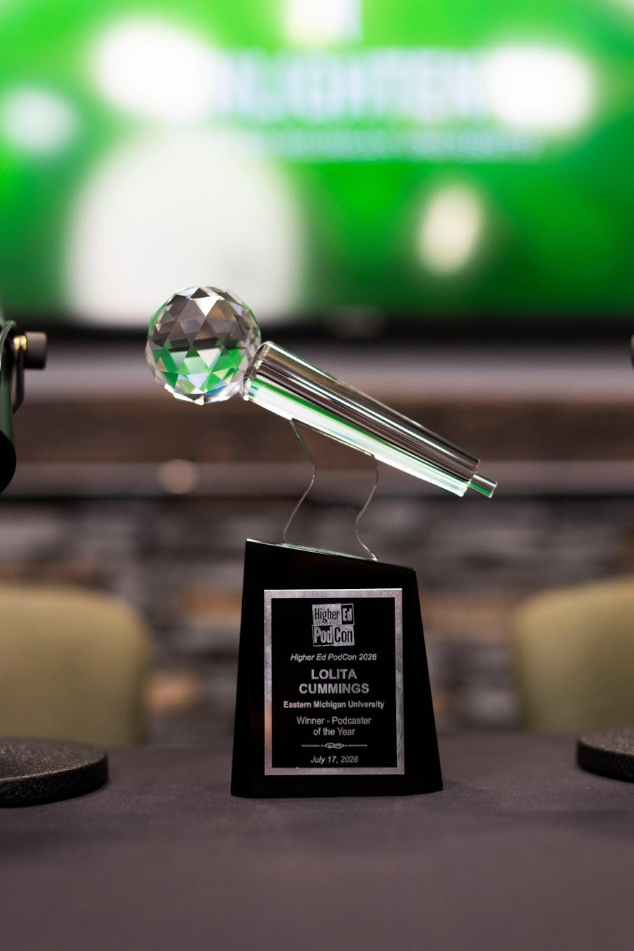 A trophy that has a clear, crystal-like microphone.