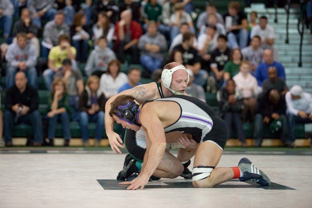 Northwestern’s Robert Kellog (bottom) in his major decision over Lester France.