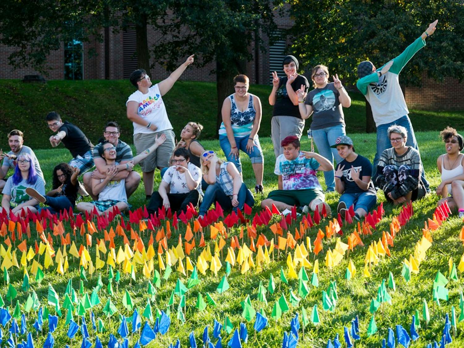 Eastern Michigan students pose for a picture after completing the OUTober Flag Display outside Pray-Harrold on EMU's campus, 7 Oct.