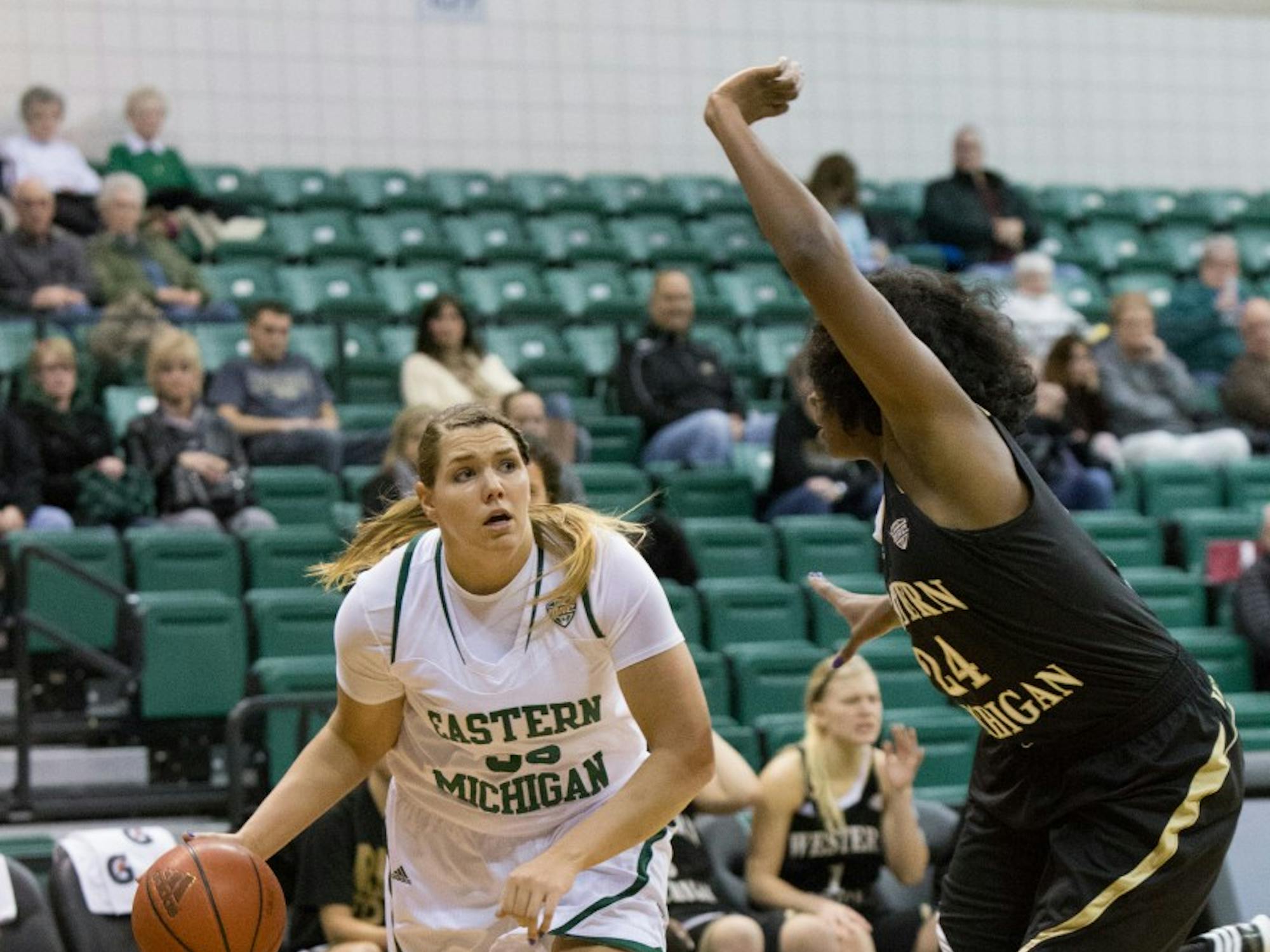 EMU forward Olivia Fouty (33) drives past WMU's Miracle Woods (24) in Eastern Michigan's 83-77 win over Western Michigan Wednesday night. Fouty had 14 points.