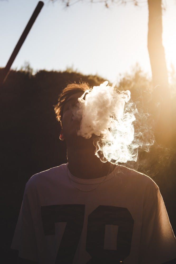 Man vaping in the sunlight