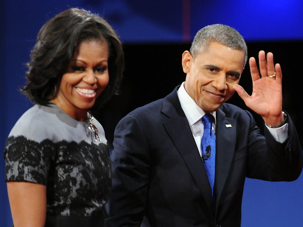 President Barack Obama waves to the audience as he and first lady Michelle Obama exit the stage at the end of the final presidential debate at Lynn University in Boca Raton, Florida on Monday, October 22, 2012. (Robert Duyos/Sun Sentinel/MCT)